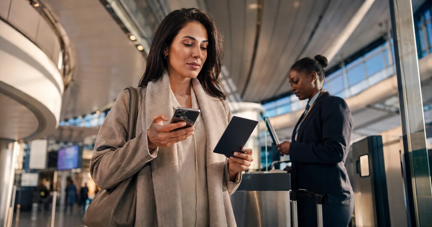 An international traveller confirming digital UK immigration status before departure